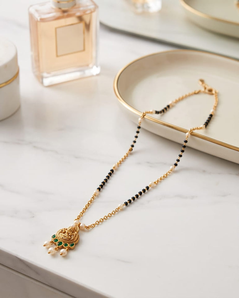 Gold-Toned Mangalsutra with Lakshmi Pendant & Green Stone Detailing